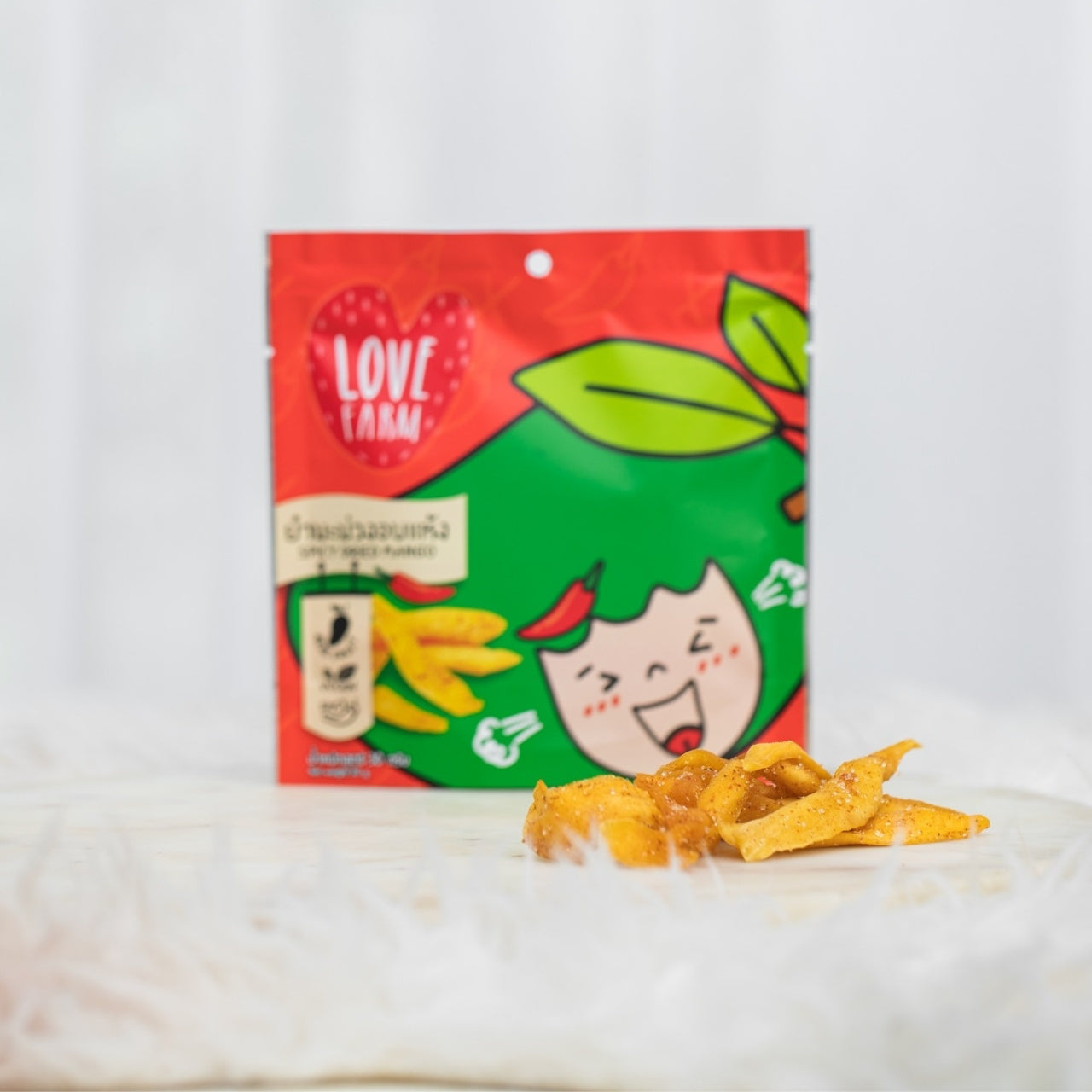 Love Farm Spicy Dried Mango – Sweet and chewy dried mango infused with a bold chili kick for a perfect balance of fruity and spicy flavors.